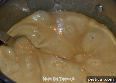 Crunchy Caramel Corn with Autumn Leaf Tags 7 Warm caramel being poured over popcorn in a large mixing bowl or baking dish