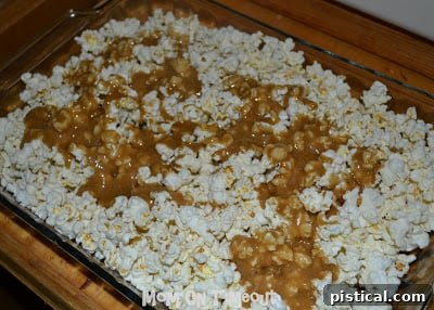 Crunchy Caramel Corn with Autumn Leaf Tags 8 Caramel-coated popcorn spread evenly in baking pans, ready for the oven