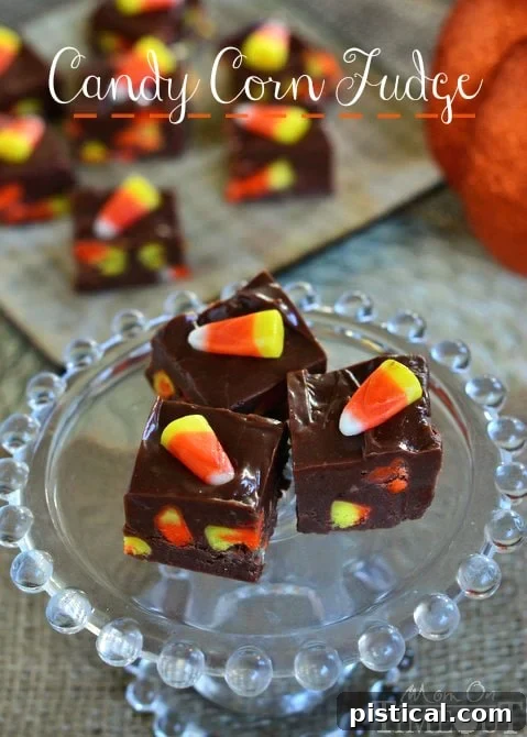 Rich chocolate Candy Corn Fudge squares beautifully arranged, showcasing the embedded yellow, orange, and white candy corn pieces.