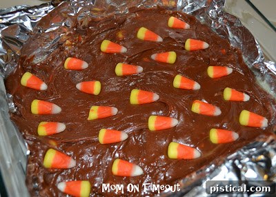 Freshly cut Candy Corn Fudge squares arranged on a white plate, ready to be served.