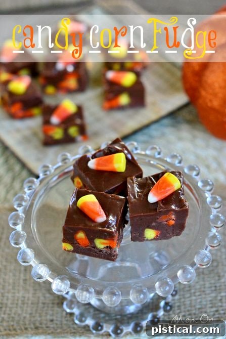 An overhead shot of numerous squares of Candy Corn Fudge arranged on a wooden board, ready for a Halloween party.