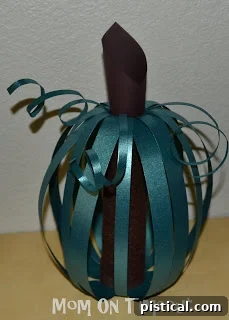 Whimsical Gourd Wonders 11 The final completed Scrappy Pumpkin, showcasing the elegant design achieved with scrapbook paper and a cardboard base.