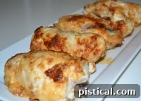 Cooked chicken cordon bleu resting on a plate