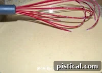 Whisking cream mixture into pan drippings
