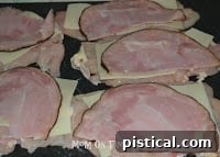 Layering ham over Swiss cheese on chicken