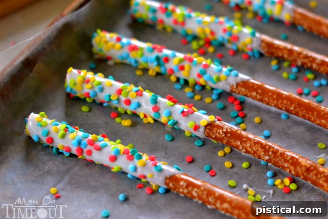 Easy Rainbow Pretzel Wands take just minutes to make and are perfectly scrumptious! | MomOnTimeout.com