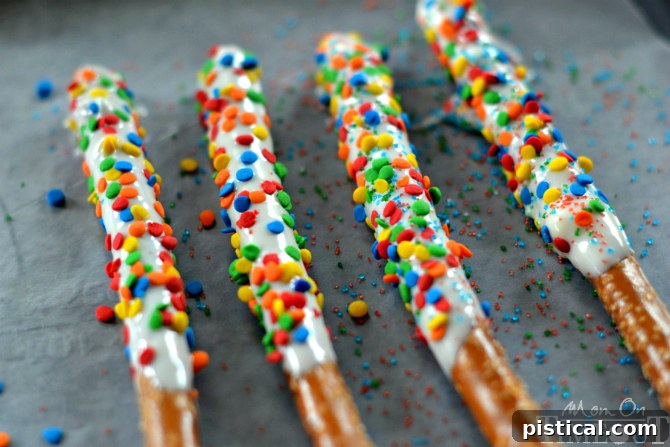 Fun and easy, these Rainbow Pretzel Wands take just minutes to make and are perfectly scrumptious! | MomOnTimeout.com
