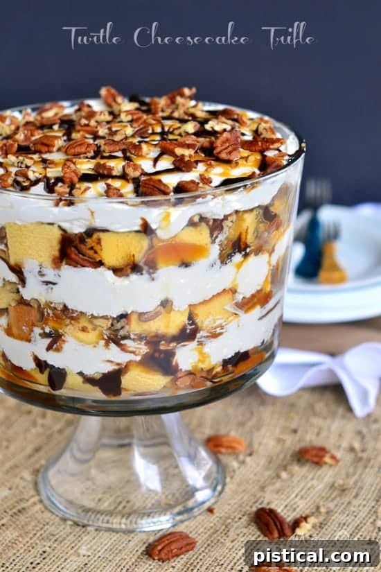 A stunning Turtle Cheesecake Trifle featuring layers of rich caramel, smooth chocolate fudge, crunchy pecans, creamy no-bake cheesecake, and moist pound cake in a clear trifle dish.