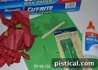 Craft materials for Stained Glass Fall Leaves: glue, tissue paper, waxed paper, templates.