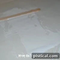 Measuring and tearing a piece of waxed paper for the craft.