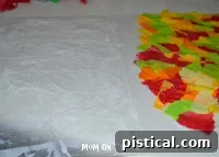 Half of the waxed paper covered with an assortment of colorful tissue paper.