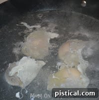 Eggs poaching gently in a pot of simmering water with vinegar.