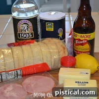 Ingredients for Eggs Benedict laid out on a kitchen counter: English muffins, Canadian bacon, eggs, lemon, butter, vinegar, and spices.
