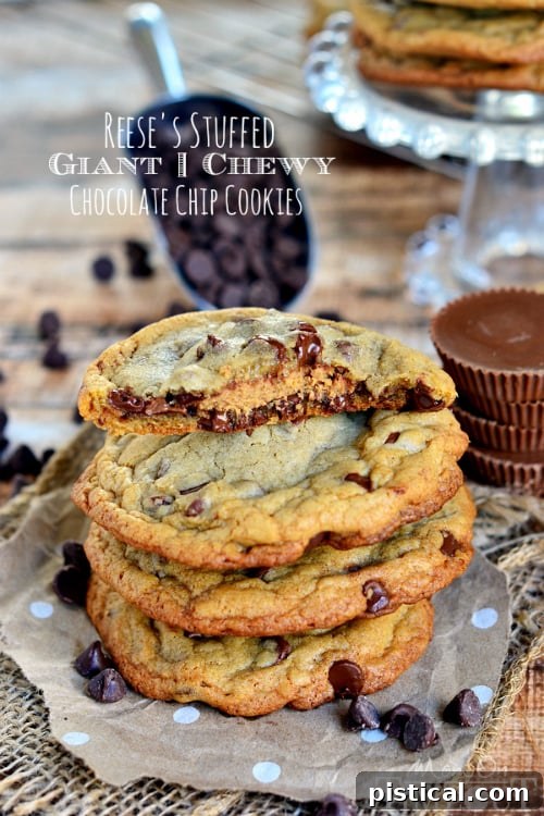 Reese's Stuffed Giant Chewy Chocolate Chip Cookies satisfy the deepest chocolate and peanut butter cravings! Chewy, delicious, and stuffed with a peanut butter cup... you can thank me later. // Mom On Timeout #chocolatechipcookies #reeses #baking #dessert #recipe Close-up of a warm Reese's Stuffed Giant Chewy Chocolate Chip Cookie with a visible peanut butter cup center.