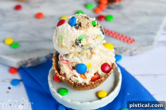 Close-up of Monster Cookie Dough Ice Cream, showing colorful M&Ms, chocolate chips, and cookie dough chunks embedded in the creamy base, highlighting its texture and visual appeal.