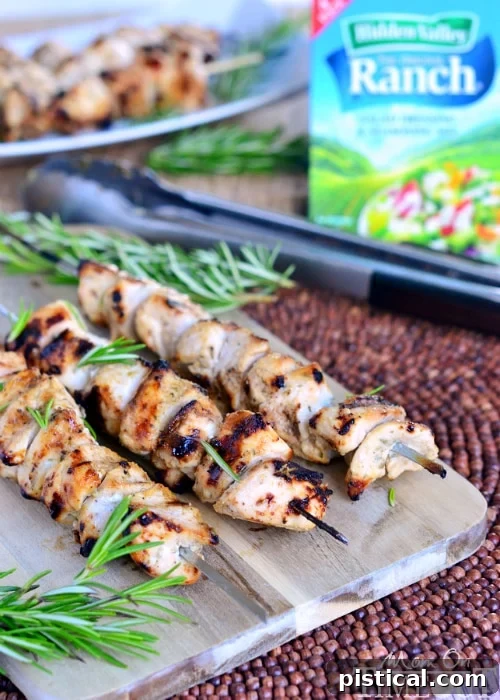 Rosemary Buttermilk Ranch Chicken Skewers grilling on an outdoor barbecue