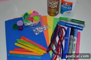 Materials needed for a simple butterfly craft, including foam sheets, glue, popsicle sticks, pipe cleaners, pom-poms, pens, glitter glue, foam stickers, and googly eyes