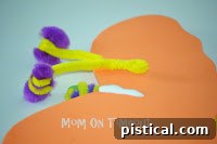 Finished butterfly craft with pipe cleaner antennae attached to the back of the butterfly's head area