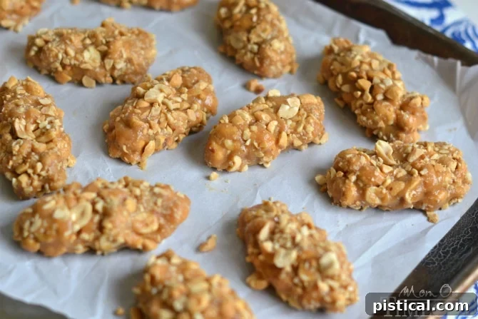 Easy, no-bake peanut butter candy bars being prepared on a baking sheet, showcasing the simple process.
