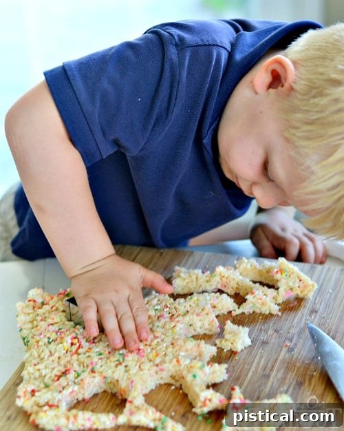 Hands using cookie cutters to shape Funfetti Rice Krispies Treats before assembling kabobs