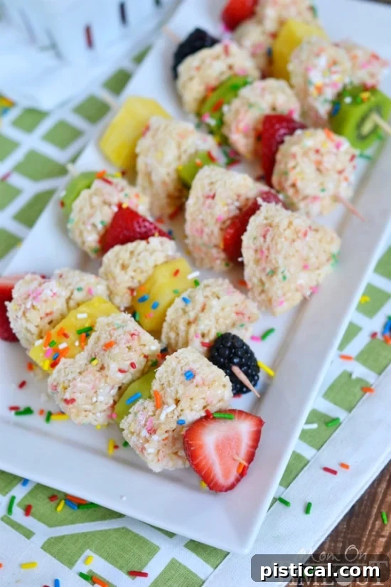 Assembling Funfetti Rice Krispies Treats Fruit Kabobs with fresh fruit and shaped treats
