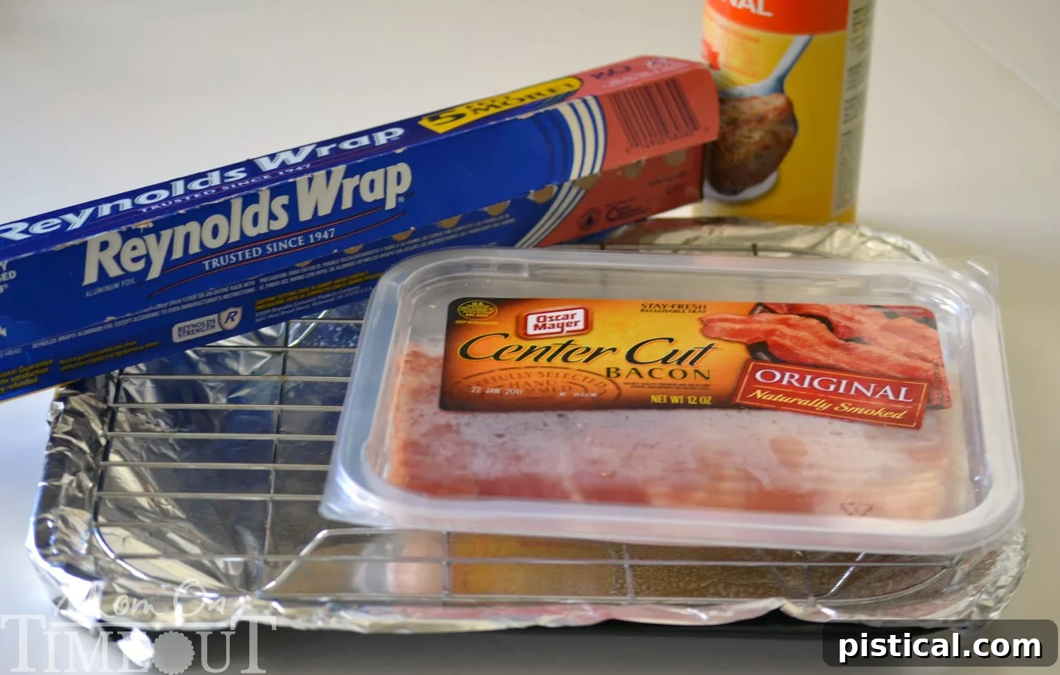 Close-up of bacon strips laid out on a foil-lined baking sheet, ready for the oven, illustrating proper spacing.