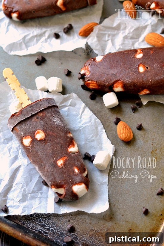 Rocky Road Pudding Pops garnished with extra chocolate chips and marshmallows, ready to be enjoyed | MomOnTimeout.com