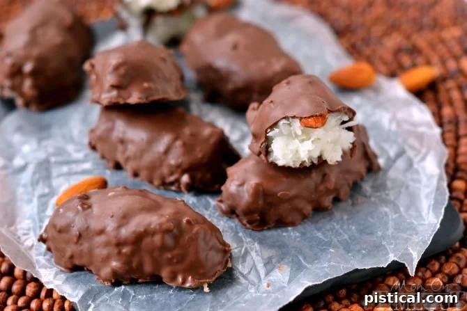 The classic Almond Joy dilemma: A perfect almond sits atop a luscious coconut candy bar, ready to be enjoyed. Recipe by MomOnTimeout.com