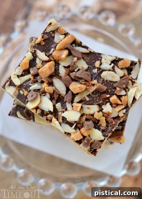 A close-up view of Toffee Cookie Bars, showcasing the glossy chocolate, sliced almonds, and Heath toffee bits