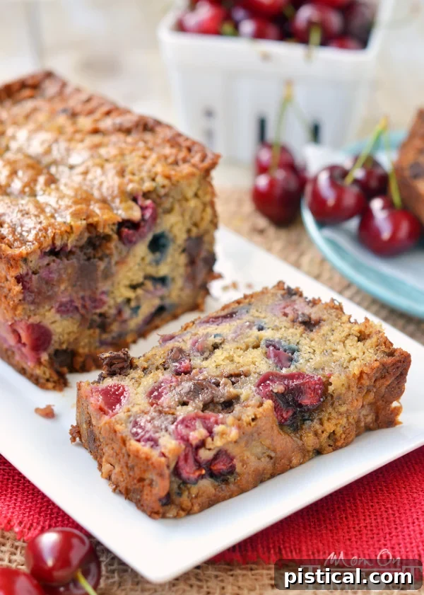 Freshly baked Chocolate Cherry Banana Bread cooling in a loaf pan, ready to be sliced and enjoyed.