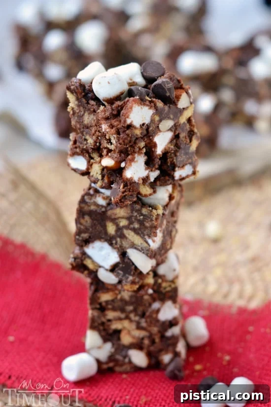 A close-up of finished Rocky Road S'mores Bars cut into squares, showcasing the textured top and gooey interior.