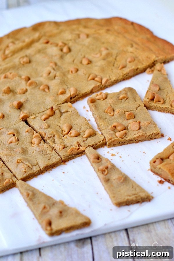 Double Trouble Peanut Butter Cookie Bars cooling on parchment paper after baking.