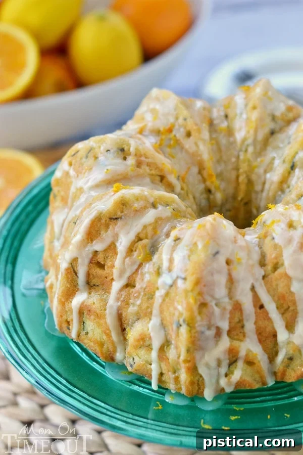 Velvet Zucchini Bundt 5 A close-up of the Zucchini Bundt Cake with Orange Glaze, highlighting the thick, sweet, and zesty glaze cascading down the sides.