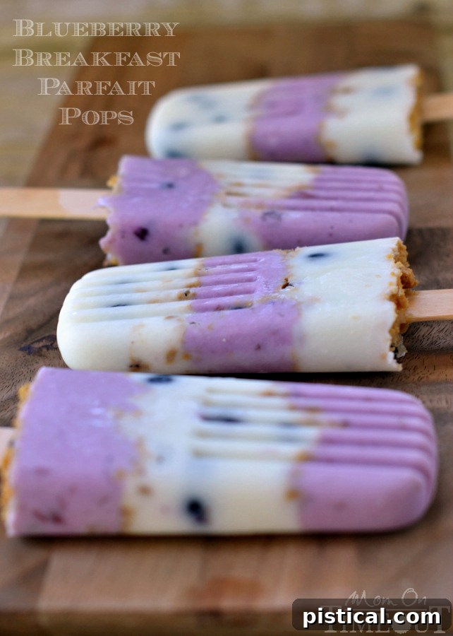 Close-up of Blueberry Breakfast Parfait Pops with layers of Greek yogurt and crushed biscuits. MomOnTimeout.com #ad