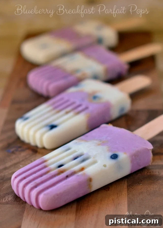 Close-up of a Blueberry Breakfast Parfait Pop showing the delicious layers of fruit, yogurt, and biscuit. MomOnTimeout.com #ad