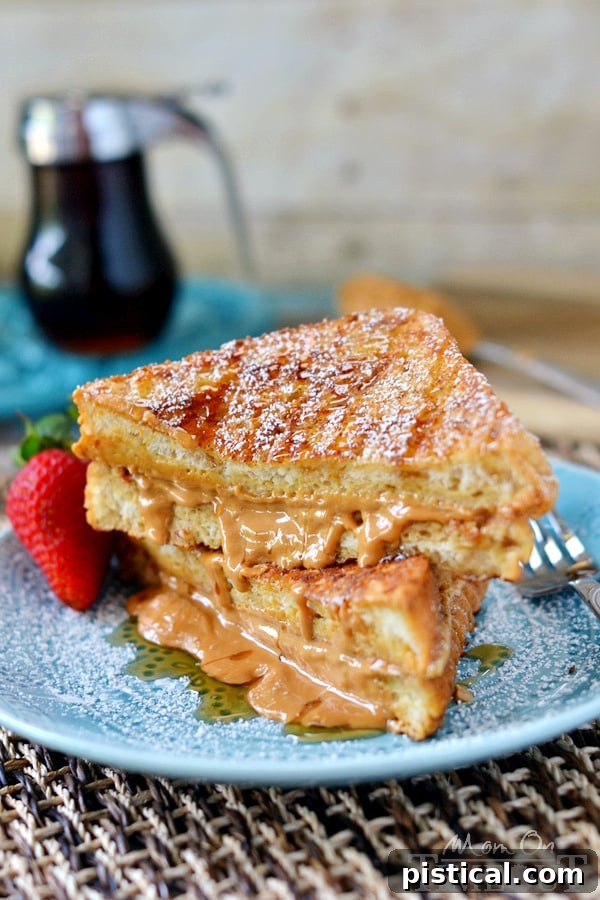 A stack of Peanut Butter Stuffed French Toast with fresh strawberries and bananas