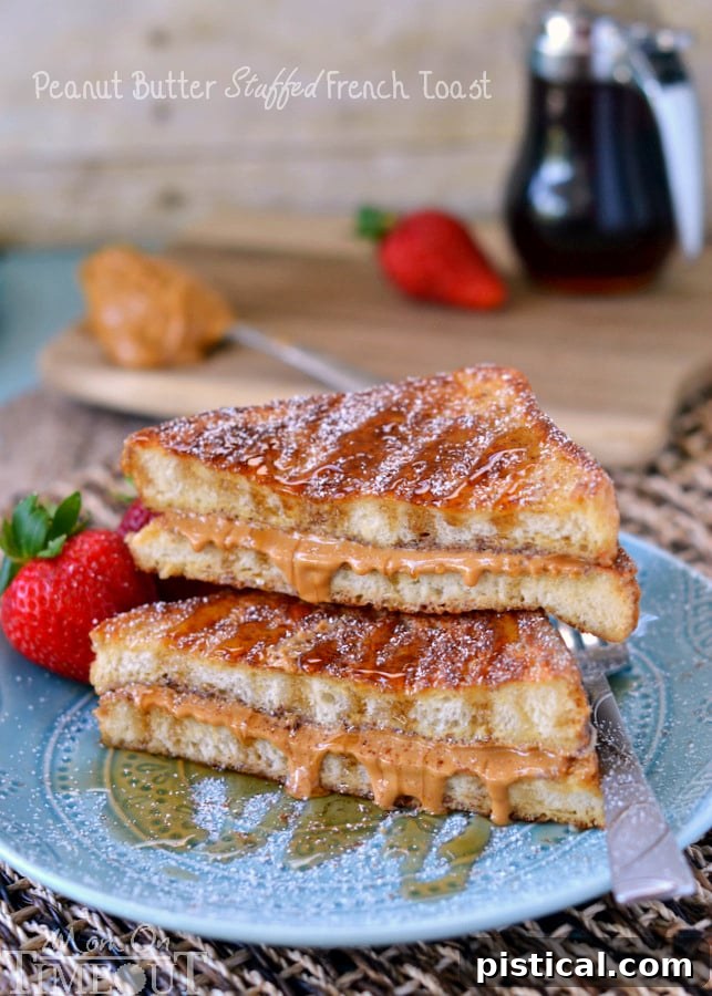 Two slices of Peanut Butter Stuffed French Toast on a plate, ready to be enjoyed