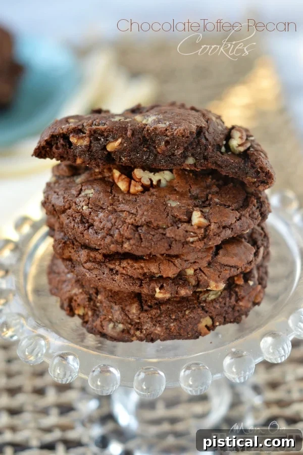 Ultimate Chocolate Toffee Pecan Cookies 4 Several rich and fudgy Chocolate Toffee Pecan Cookies arranged on a cooling rack, showcasing their generous size and tempting golden-brown edges.