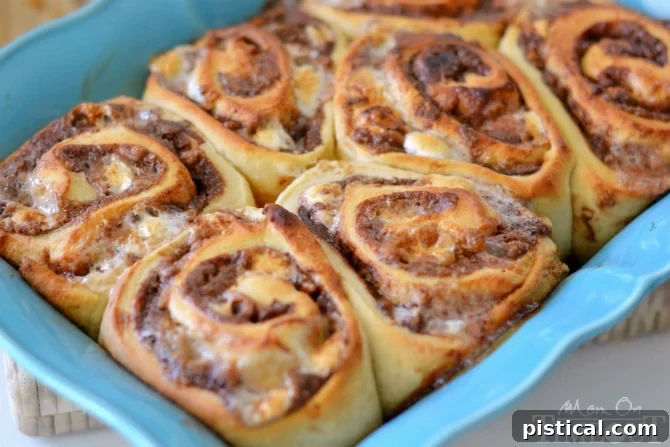Baked S'mores Cinnamon Rolls with perfectly toasted marshmallows, fresh out of the oven, tempting and golden