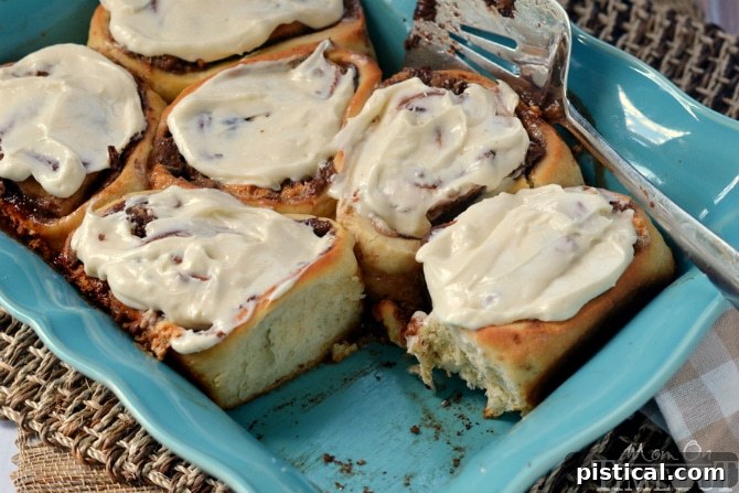 S'mores Cinnamon Rolls generously covered with luscious Marshmallow Cream Cheese Frosting, a delightful breakfast or dessert