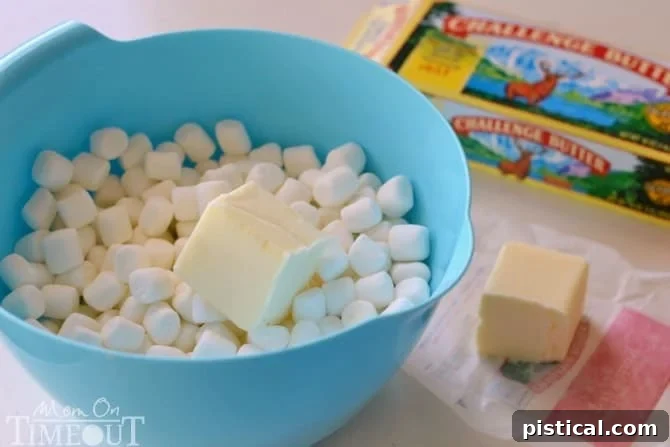 Smores Swirl Krispie Pinwheels 5 Step-by-step: Mixing melted marshmallows, butter, Rice Krispies cereal, and graham cracker crumbs for the S'mores Pinwheel base layer.