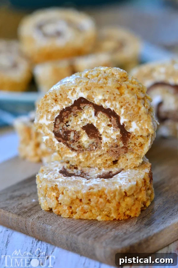 Smores Swirl Krispie Pinwheels 8 Perfectly sliced S'mores Rice Krispies Treats Pinwheels arranged and ready to be served, highlighting their inviting layers.