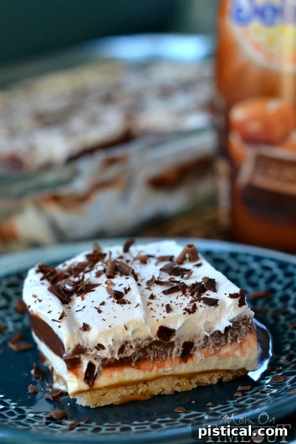 Golden Caramel Chocolate Dream 5 Experience the Joy of Effortless Entertaining with This Make-Ahead Chocolate Caramel Layered Dessert. Prepare in advance and impress your guests with minimal stress. MomOnTimeout.com #makeahead #partyfood #dessertideas #hostesswiththemostess