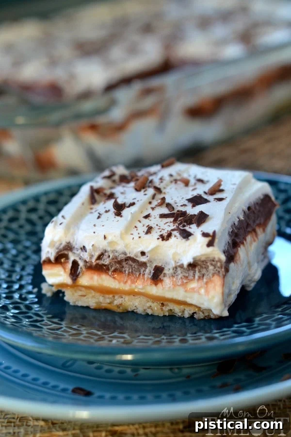Golden Caramel Chocolate Dream 6 Your Go-To Dessert for Summer Parties and Potlucks! This Chocolate Caramel Layered Dessert is easy to make, serves a crowd, and is always a hit. MomOnTimeout.com #summerdessert #potluckrecipe #familyfavorite