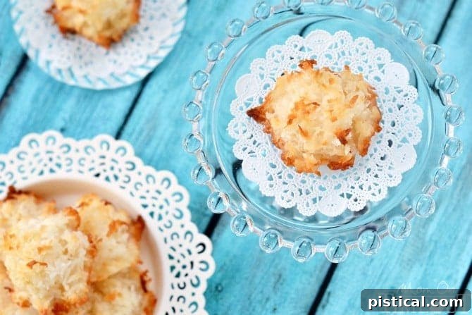 Golden Brown Coconut Macaroons A close-up of several golden brown coconut macaroons piled on a textured surface, highlighting their delicious, toasted appearance.