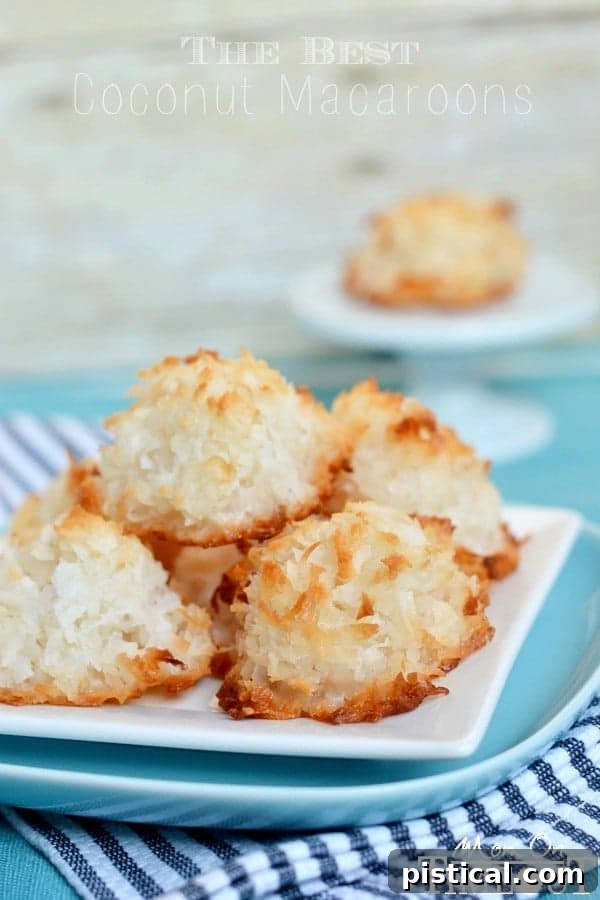 The Best Coconut Macaroons Recipe Piled High A vibrant blue plate generously piled with the best coconut macaroons, showcasing their rich color and inviting texture.