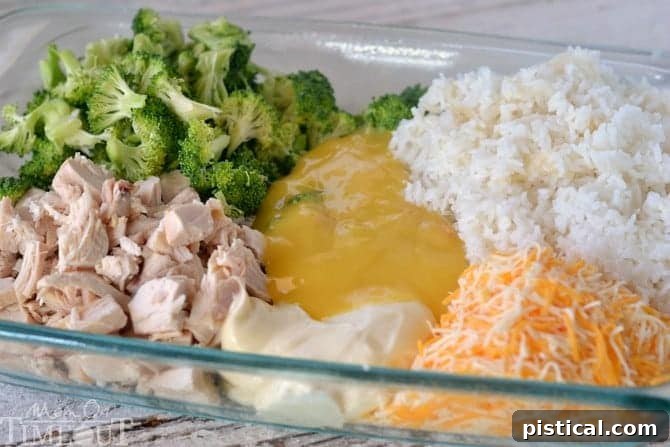 Various ingredients for Chicken Broccoli Rice Casserole, including chicken, broccoli, and rice, mixed together in a glass baking dish, ready for the oven.