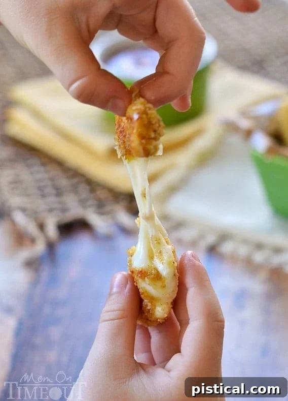 These Freezer-Friendly Baked Mozzarella Sticks are perfect for after-school snacks, late night munchies, and game day! | MomOnTimeout.com | #appetizer #cheese #recipe