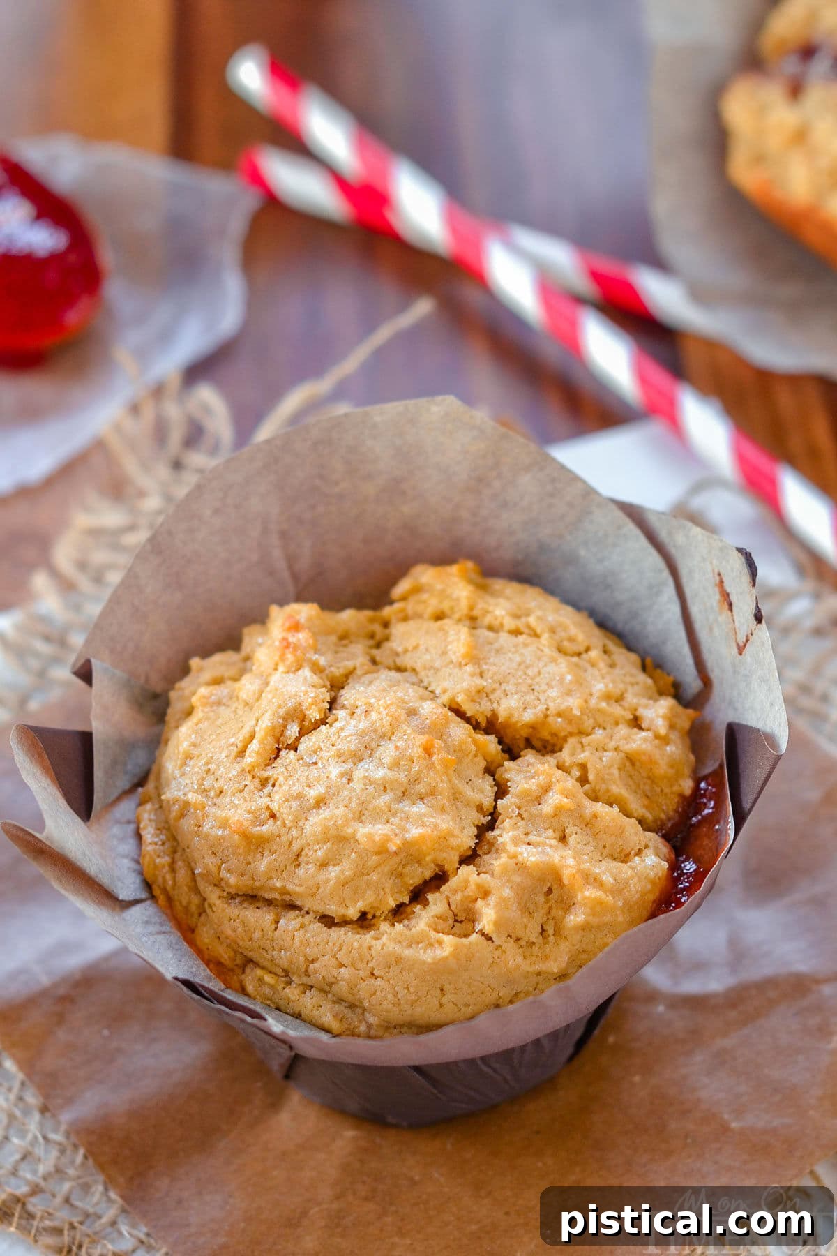 PBJ Muffins 3 Peanut butter muffin with jelly center in parchment liner ready to be enjoyed.