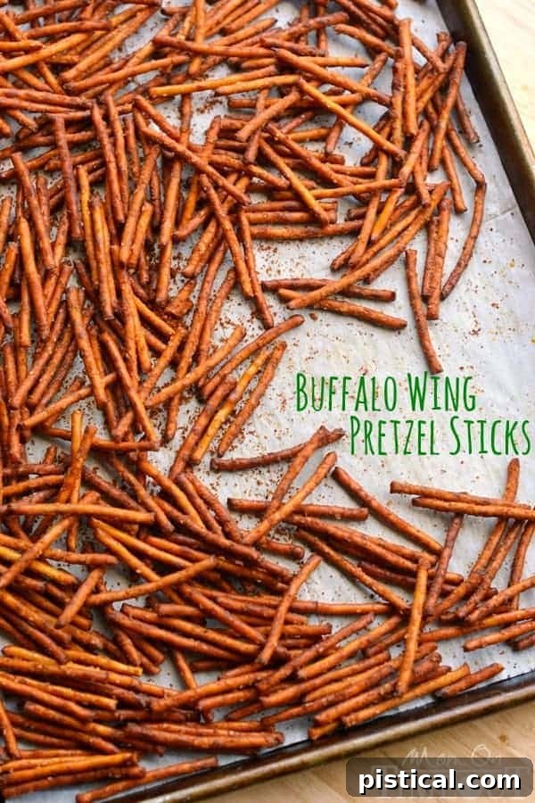 A vibrant close-up of freshly baked Buffalo Wing Pretzel Sticks, coated in rich, spicy seasoning.